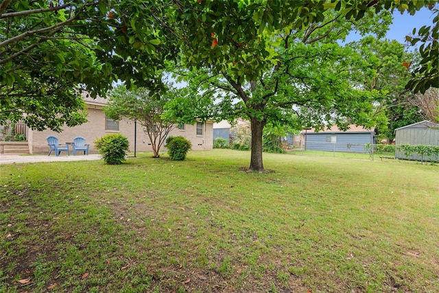 view of yard featuring fence and a patio