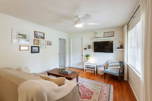 living room featuring a ceiling fan and wood finished floors