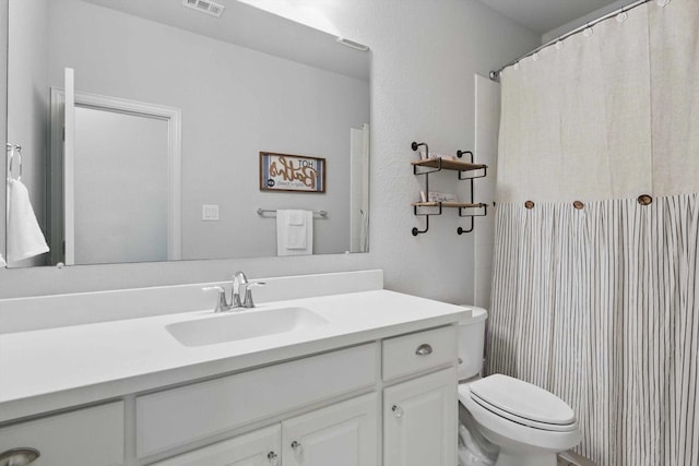 full bathroom with vanity, a shower with curtain, toilet, and visible vents