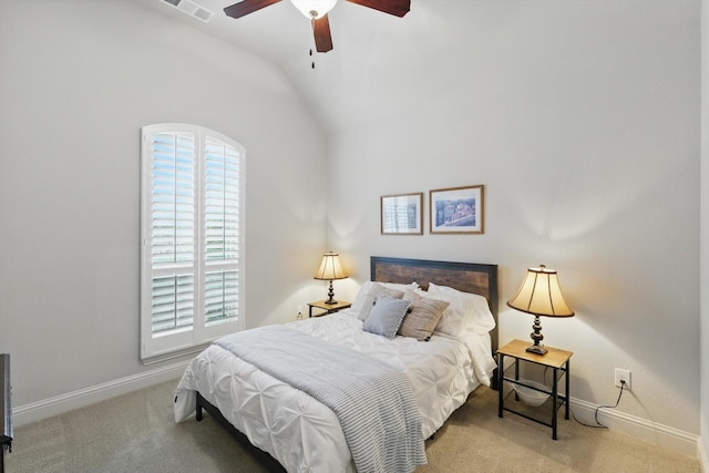 bedroom with vaulted ceiling, baseboards, and carpet flooring