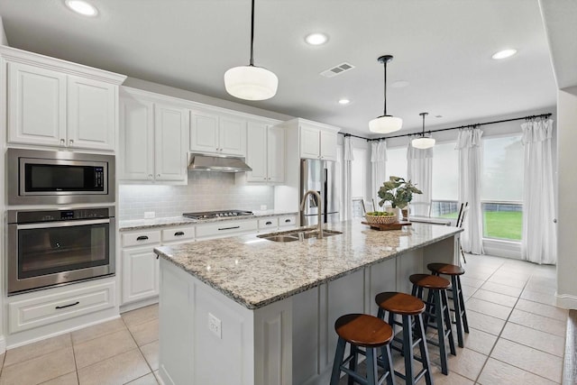 kitchen with visible vents, a sink, appliances with stainless steel finishes, and light tile patterned flooring