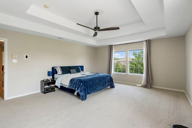 6401 Marlar Ln, The Colony, TX 75056 - bedroom with a tray ceiling, light carpet, and baseboards