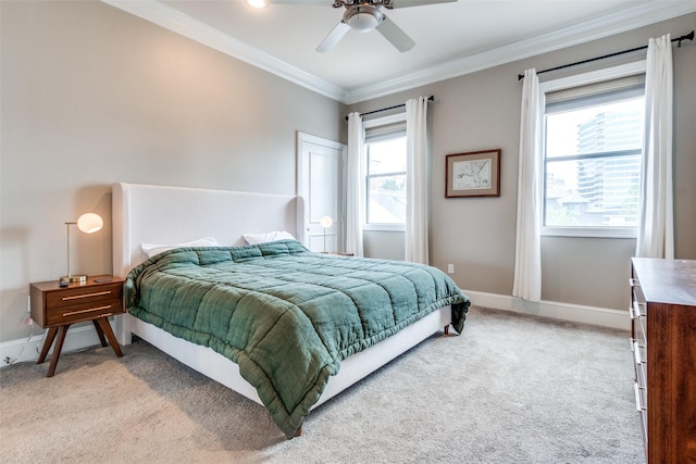 bedroom with light colored carpet, crown molding, and multiple windows