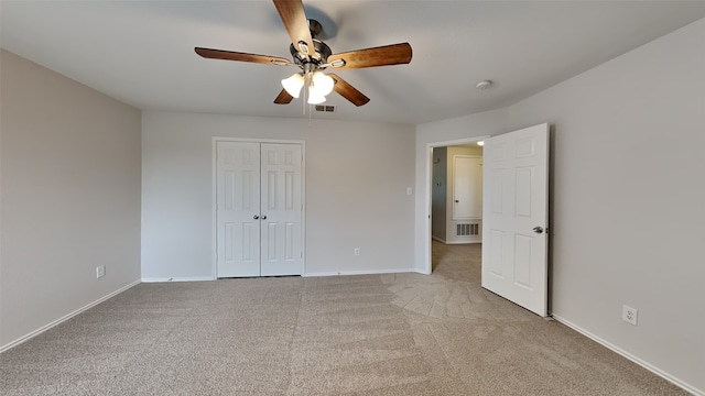 unfurnished bedroom featuring light colored carpet, baseboards, visible vents, and a closet
