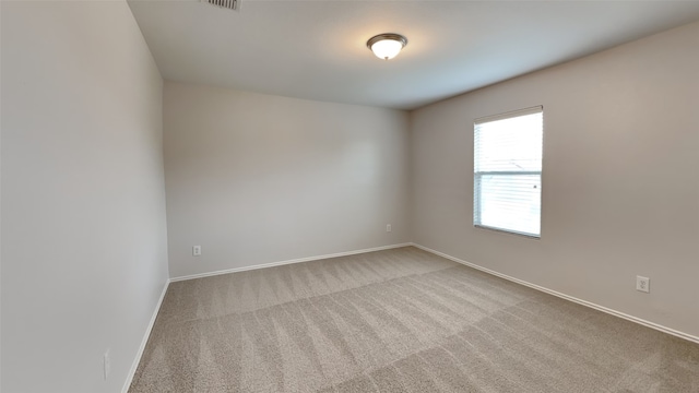 carpeted spare room with baseboards