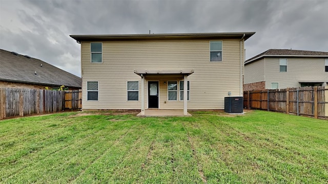 back of house featuring a yard, cooling unit, a fenced backyard, and a patio area