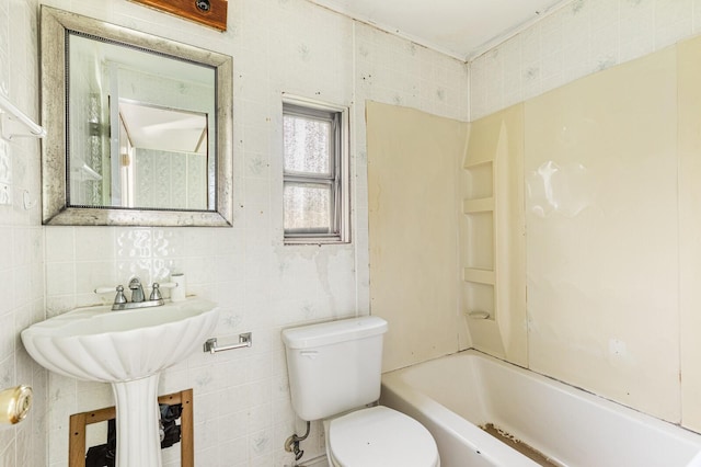 bathroom with toilet, tile walls, and bathing tub / shower combination