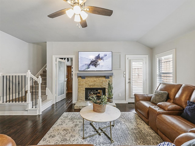 living area featuring ceiling fan, a fireplace, baseboards, stairs, and hardwood / wood-style floors