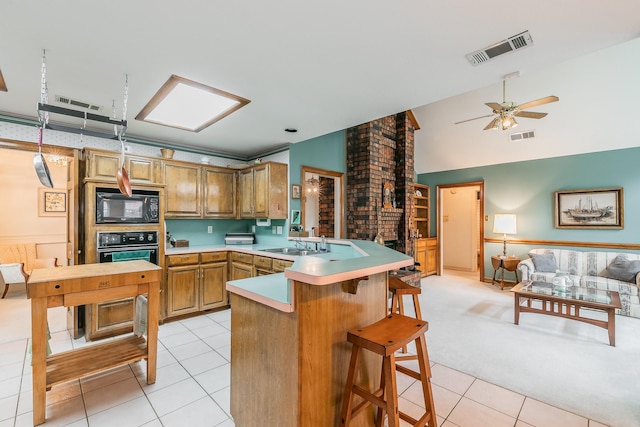 7917 Kendra Ln, North Richland Hills, TX 76182 - kitchen with black appliances, a peninsula, light tile patterned floors, a sink, and open floor plan