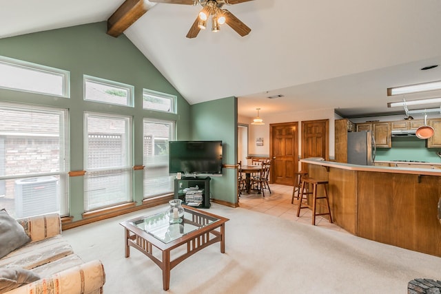 living area featuring ceiling fan, light colored carpet, cooling unit, light tile patterned floors, and beamed ceiling