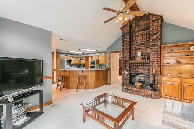 living room featuring ceiling fan, light carpet, a fireplace, vaulted ceiling with beams, and visible vents