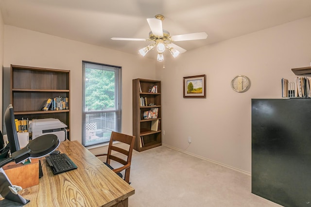 office with baseboards, light carpet, and a ceiling fan