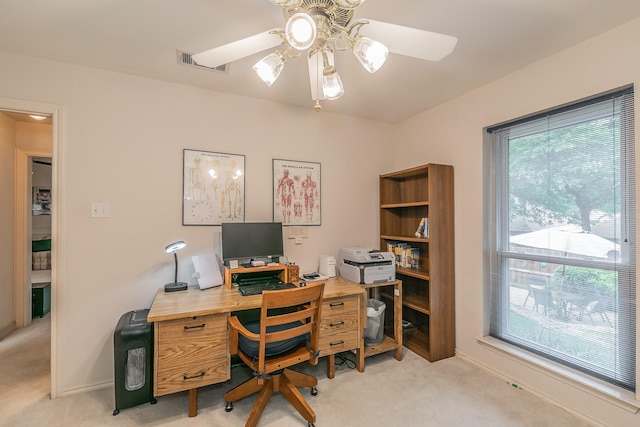 office area with a ceiling fan, light carpet, and plenty of natural light