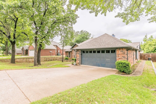 view of front facade with driveway, brick siding, fence, a front lawn, and a shingled roof