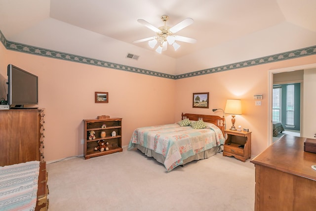 bedroom with light colored carpet, ceiling fan, visible vents, and vaulted ceiling