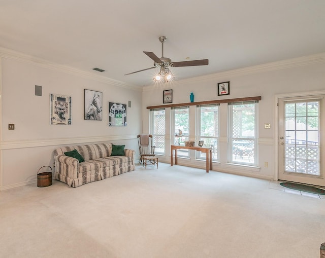 living area with carpet floors, ornamental molding, a ceiling fan, and visible vents
