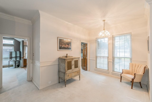 sitting room featuring crown molding, baseboards, light carpet, and a notable chandelier