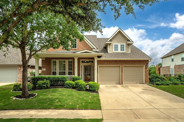 craftsman-style home with a shingled roof, driveway, a front lawn, and brick siding