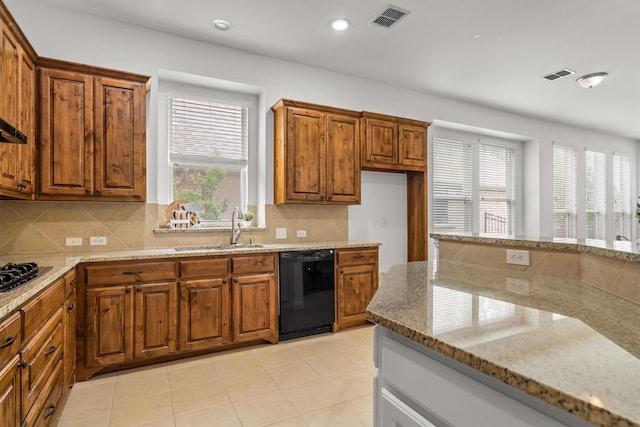 1390 Bonham Pkwy, Lantana, TX 76226 - kitchen with a sink, black appliances, brown cabinetry, and recessed lighting