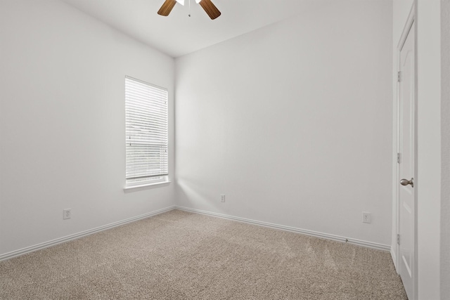 carpeted empty room with baseboards and ceiling fan