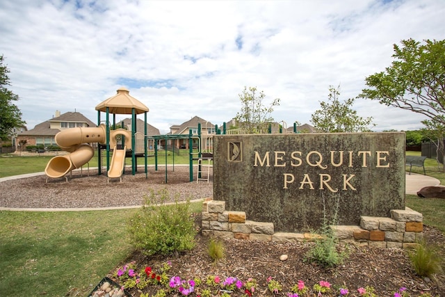 community / neighborhood sign with a lawn