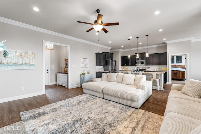 living area with crown molding, a ceiling fan, recessed lighting, and dark wood-type flooring