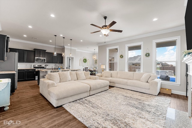 living area featuring visible vents, ornamental molding, wood finished floors, ceiling fan, and recessed lighting