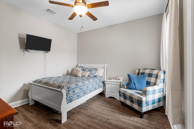 bedroom with baseboards, a ceiling fan, wood finish floors, and visible vents