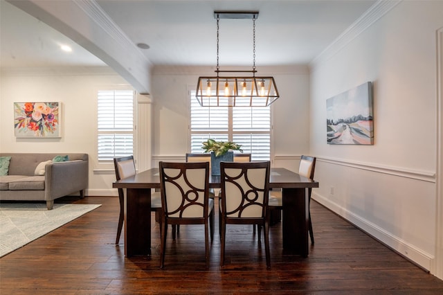 dining area featuring dark wood-style flooring, baseboards, and ornamental molding