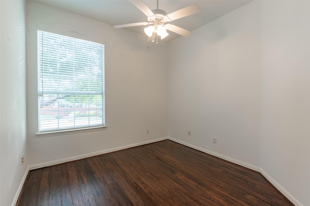 unfurnished room featuring a ceiling fan, baseboards, and dark wood-type flooring