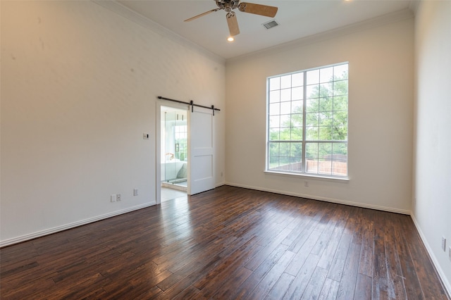 empty room featuring crown molding, plenty of natural light, dark wood-style floors, and visible vents