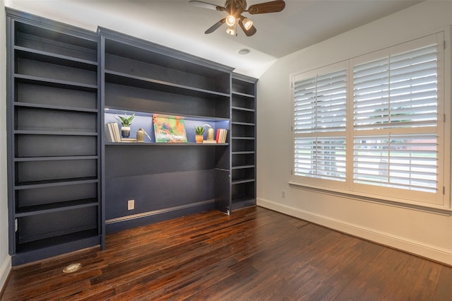 spare room with baseboards, a ceiling fan, and dark wood finished floors