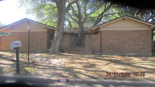 ranch-style house with brick siding