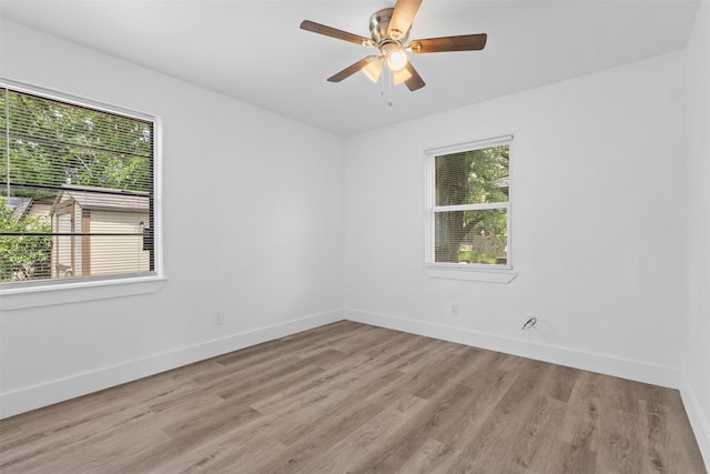 unfurnished room featuring baseboards, a ceiling fan, and wood finished floors