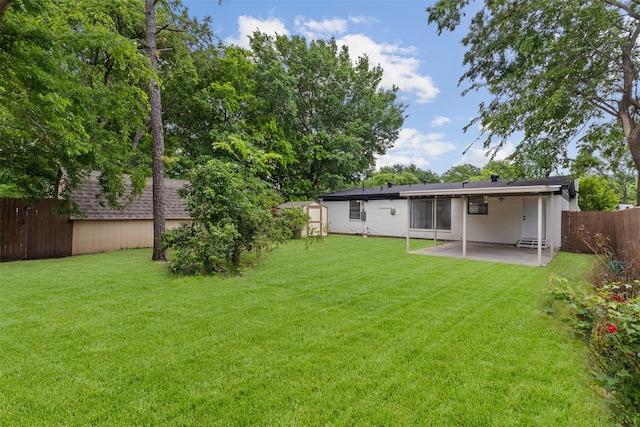 back of property featuring a fenced backyard, a yard, and a patio area