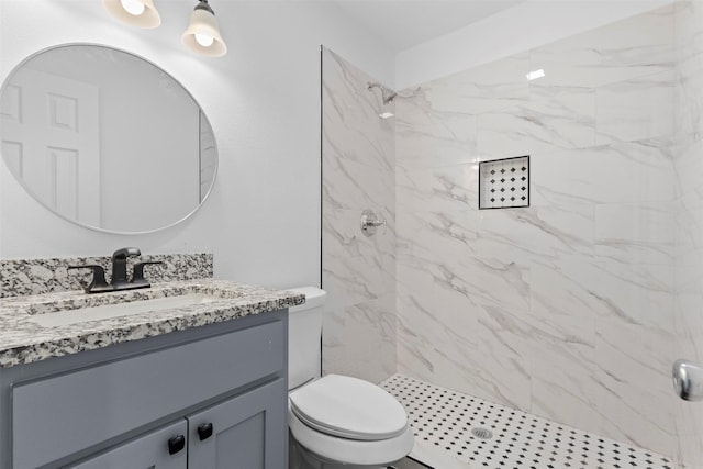 bathroom featuring vanity, a stall shower, and toilet