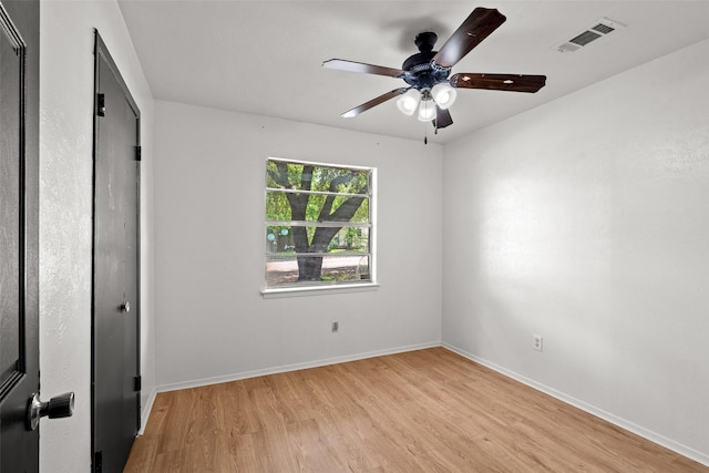 unfurnished bedroom featuring baseboards, ceiling fan, light wood-type flooring, and visible vents