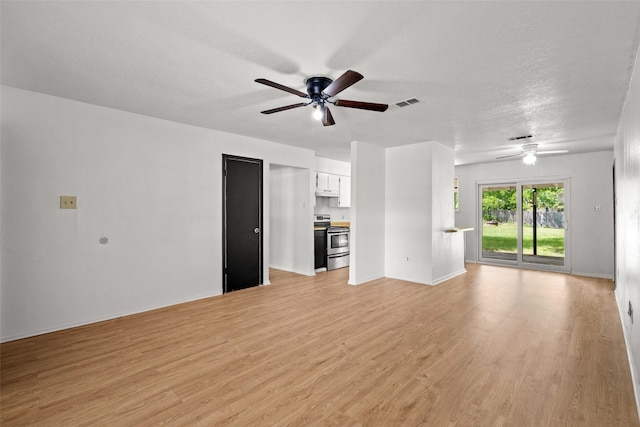 unfurnished living room featuring a ceiling fan, baseboards, visible vents, and light wood-type flooring