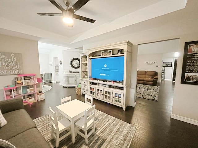 living area with baseboards, ceiling fan, and wood finished floors