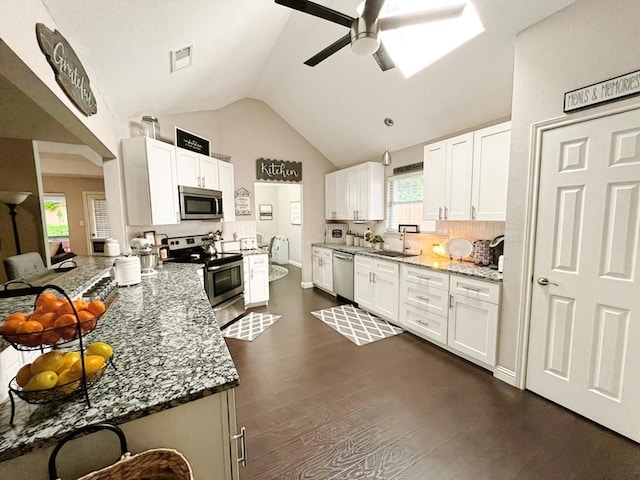 kitchen featuring a ceiling fan, visible vents, appliances with stainless steel finishes, vaulted ceiling, and a sink