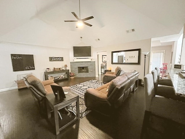 living room featuring visible vents, wood finished floors, a fireplace, a ceiling fan, and vaulted ceiling