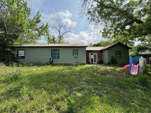 rear view of house featuring metal roof
