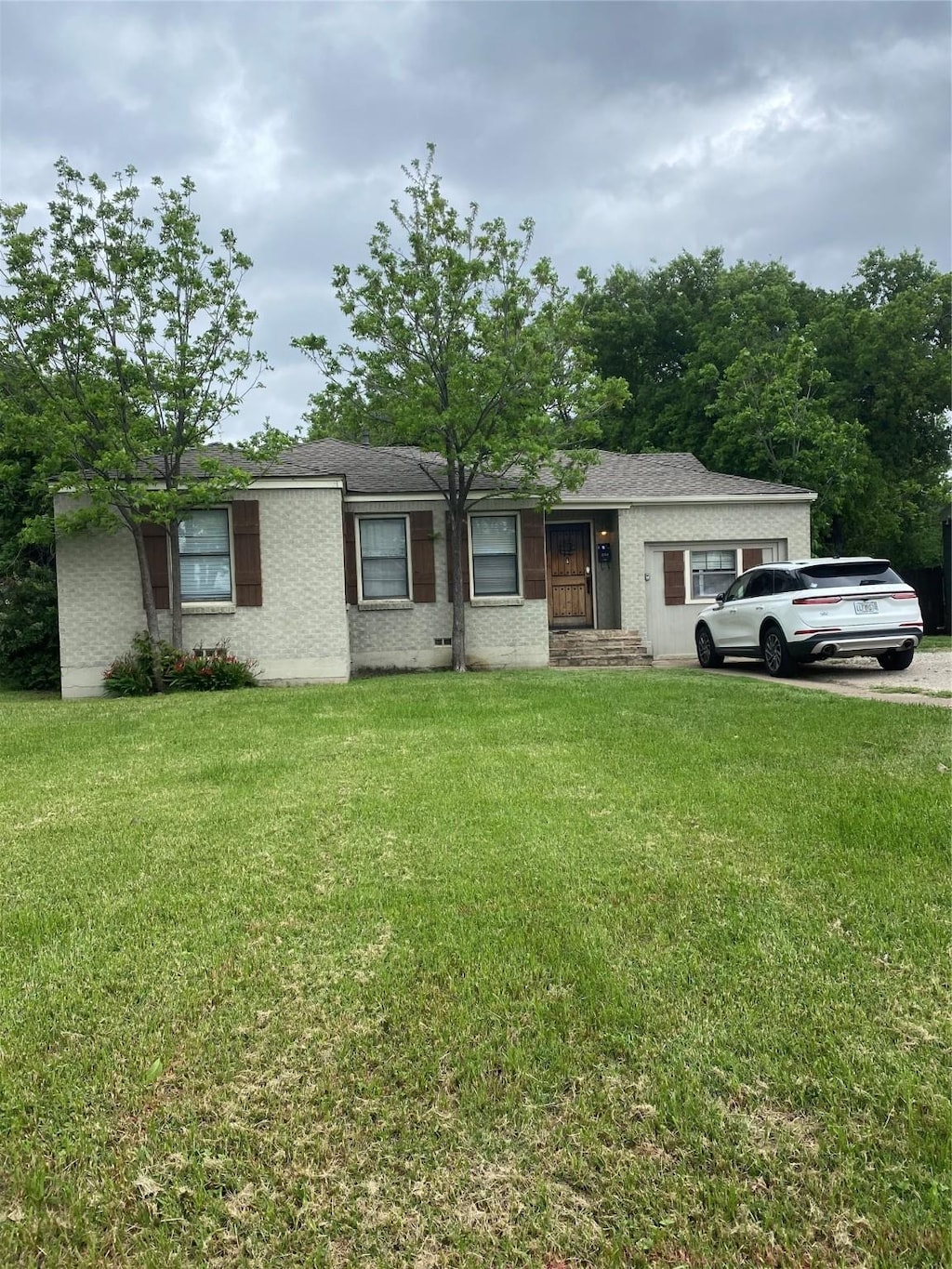 2704 W Biddison St, Fort Worth, TX 76109 - single story home with brick siding and a front lawn