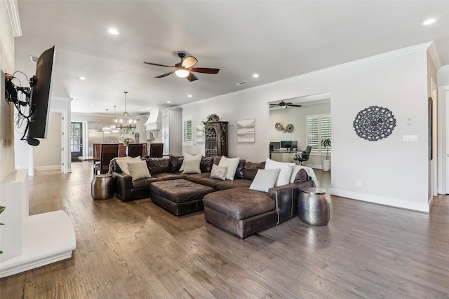 living room with crown molding, recessed lighting, wood finished floors, and ceiling fan with notable chandelier