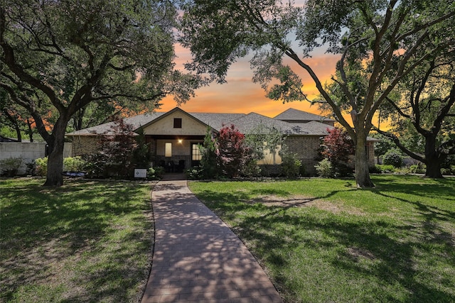 view of front of house with a yard and covered porch