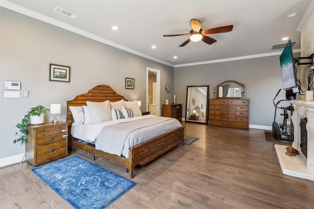 bedroom featuring crown molding, recessed lighting, wood finished floors, and visible vents