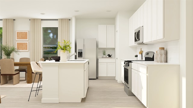 kitchen with electric range oven, tasteful backsplash, stainless steel fridge, light wood-style flooring, and an island with sink