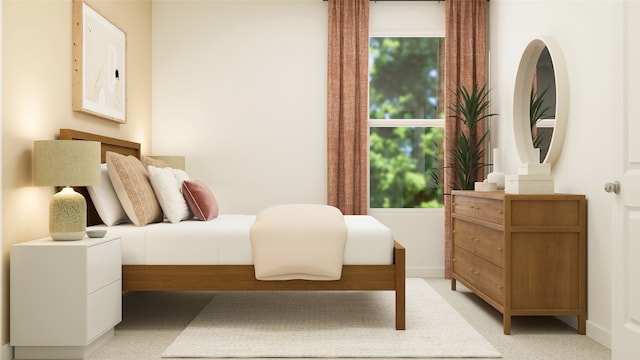 bedroom with baseboards and light colored carpet