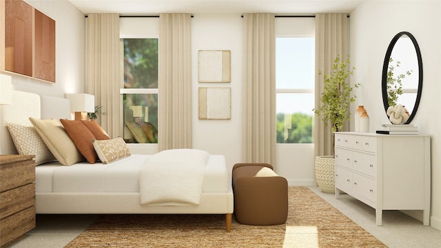 bedroom featuring baseboards, multiple windows, and light carpet