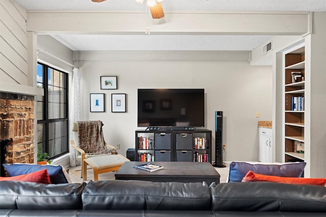 living room with ceiling fan and visible vents